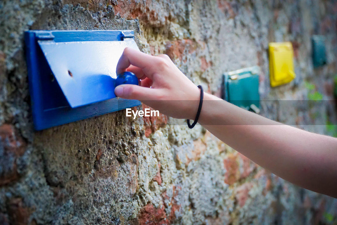 Close-up of hand opening mailbox