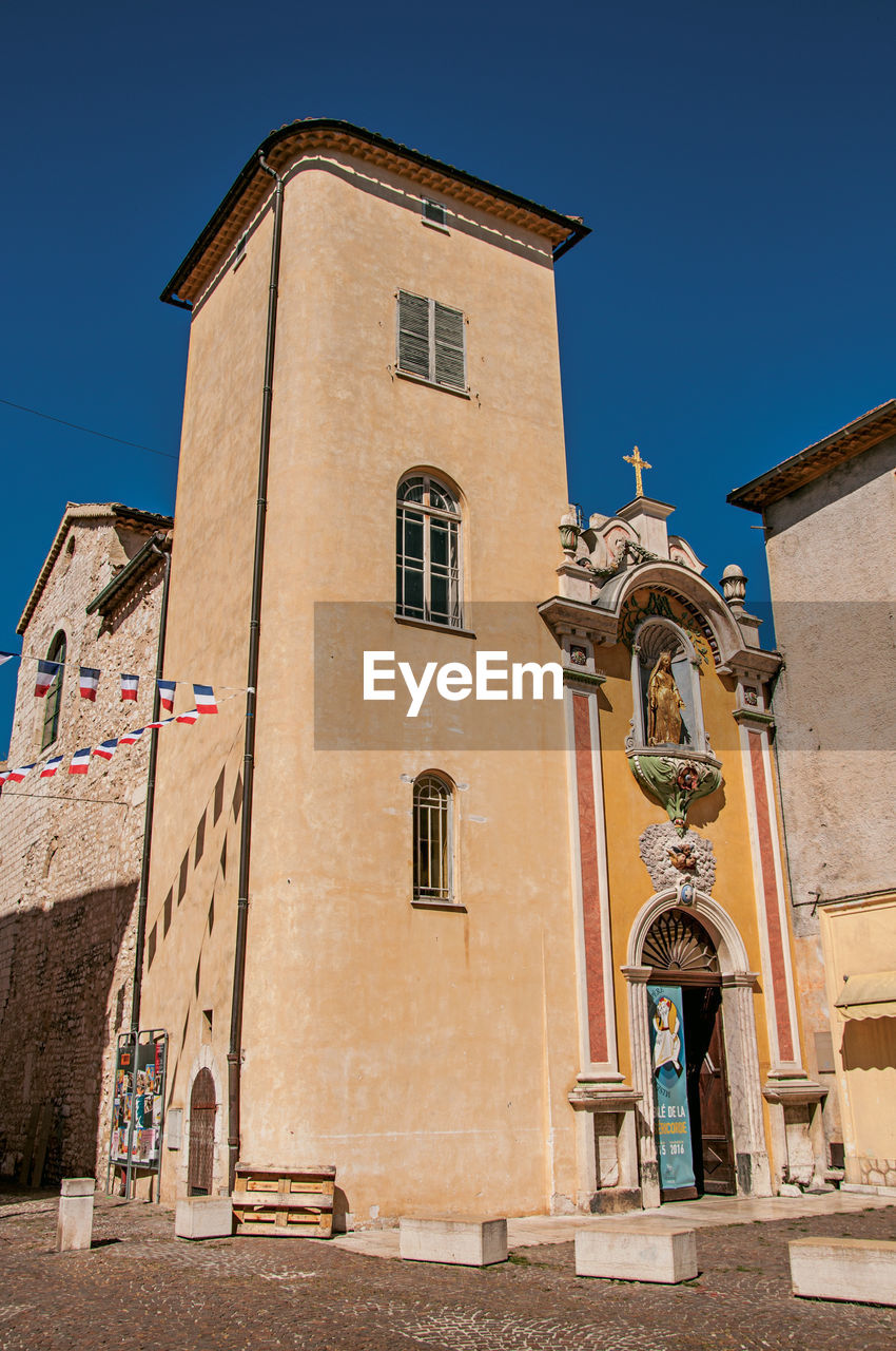 View of church facade under sunny blue sky in vence, in the french provence.
