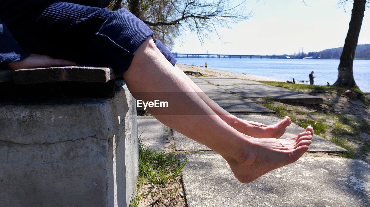 water, human leg, one person, nature, low section, adult, day, limb, leisure activity, spring, sitting, human limb, relaxation, footwear, lifestyles, women, shoe, plant, tree, sunlight, beach, sea, land, sky, outdoors, barefoot, human foot, casual clothing, holiday, trip, vacation, tranquility, clothing