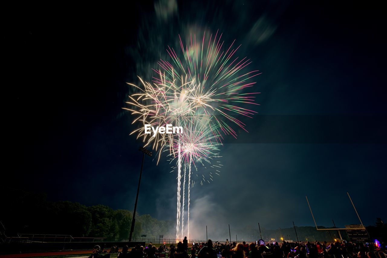 low angle view of firework display against sky at night