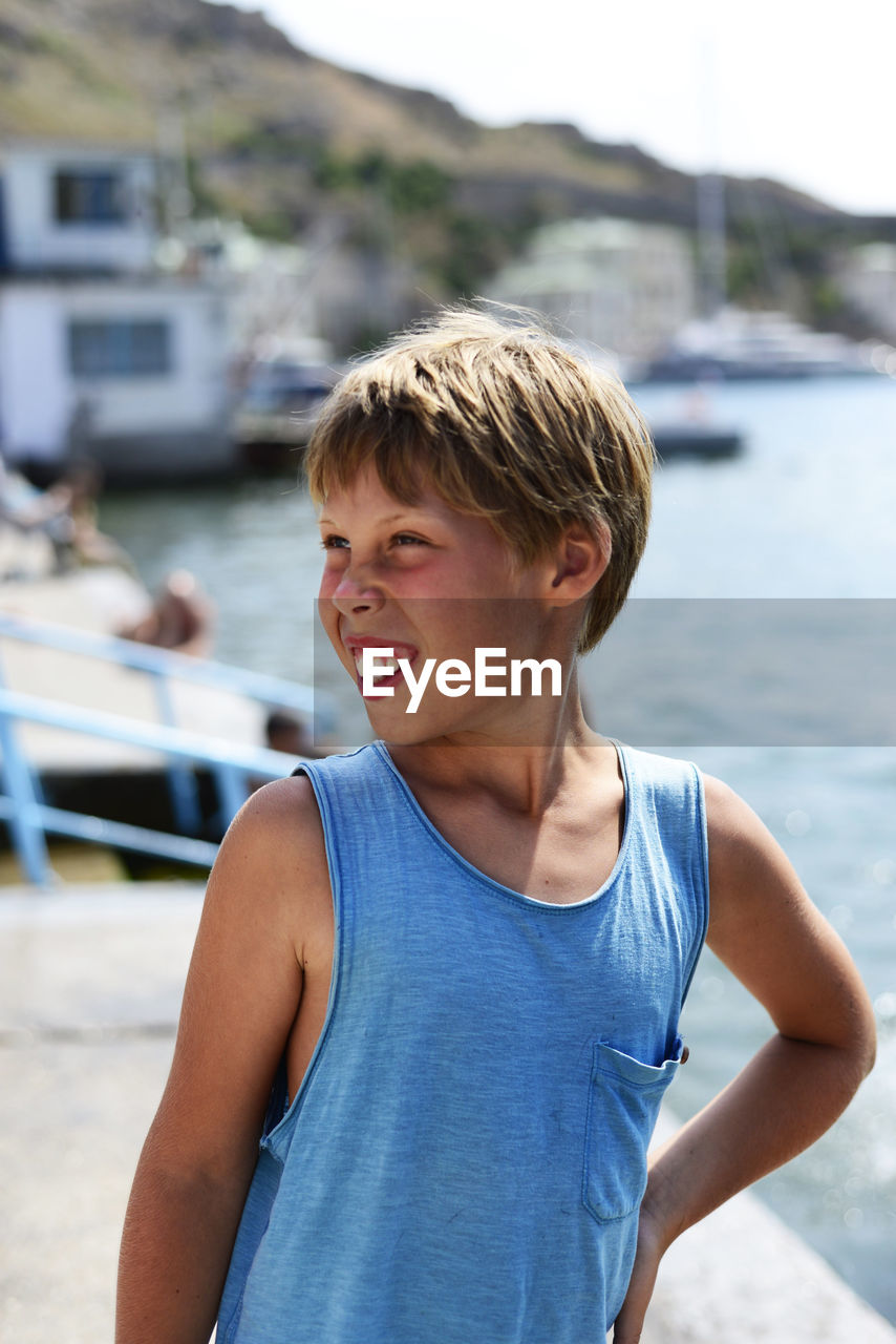 Portrait of boy standing in water