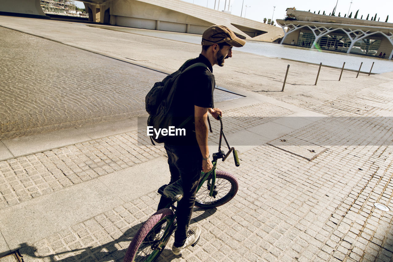 Man performing stunt on bicycle in city 