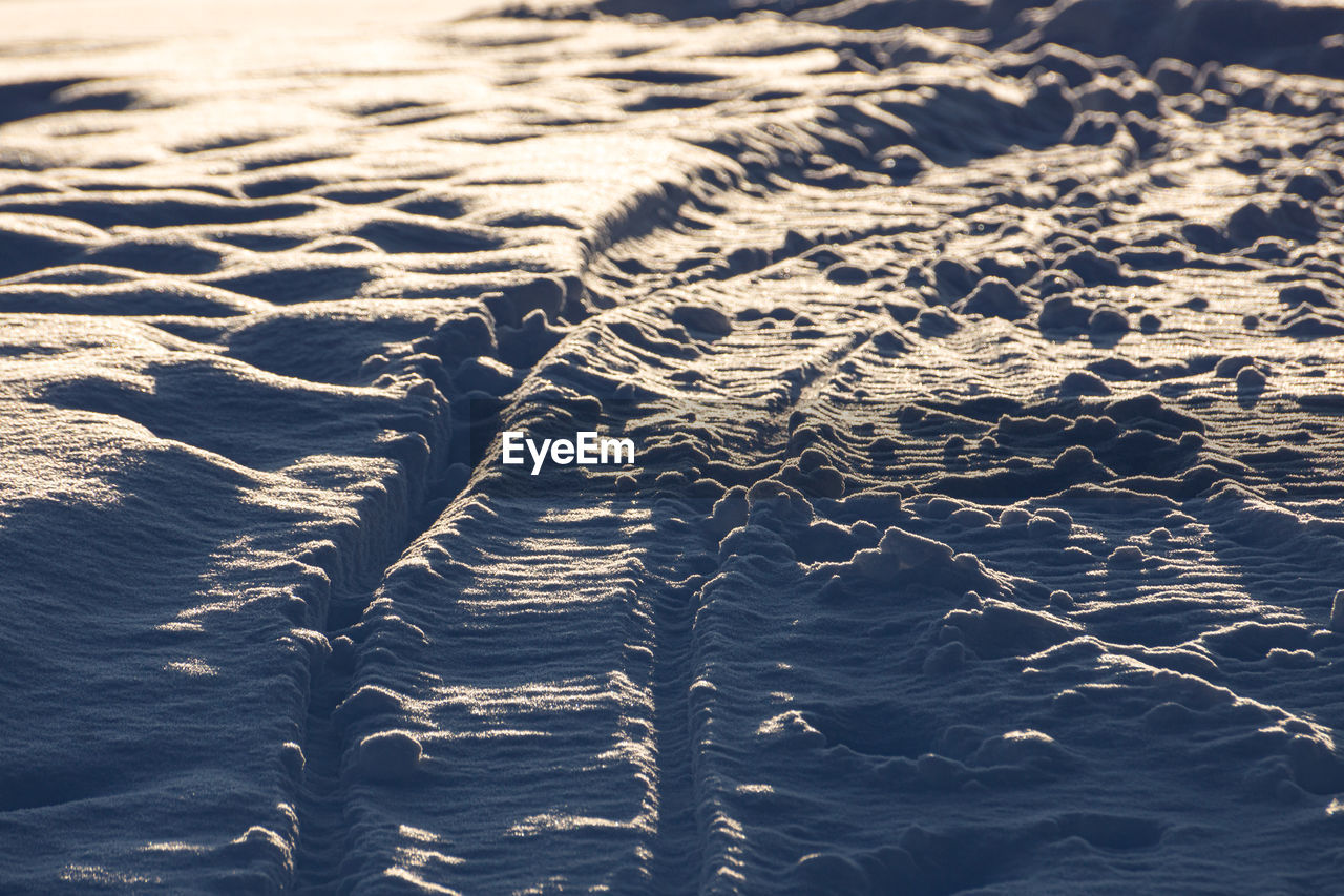 reflection, wave, water, nature, no people, sunlight, day, ocean, sea, pattern, full frame, backgrounds, beauty in nature, land, ice, high angle view, outdoors, tranquility, sand, horizon, rippled, scenics - nature, environment, close-up, beach, winter