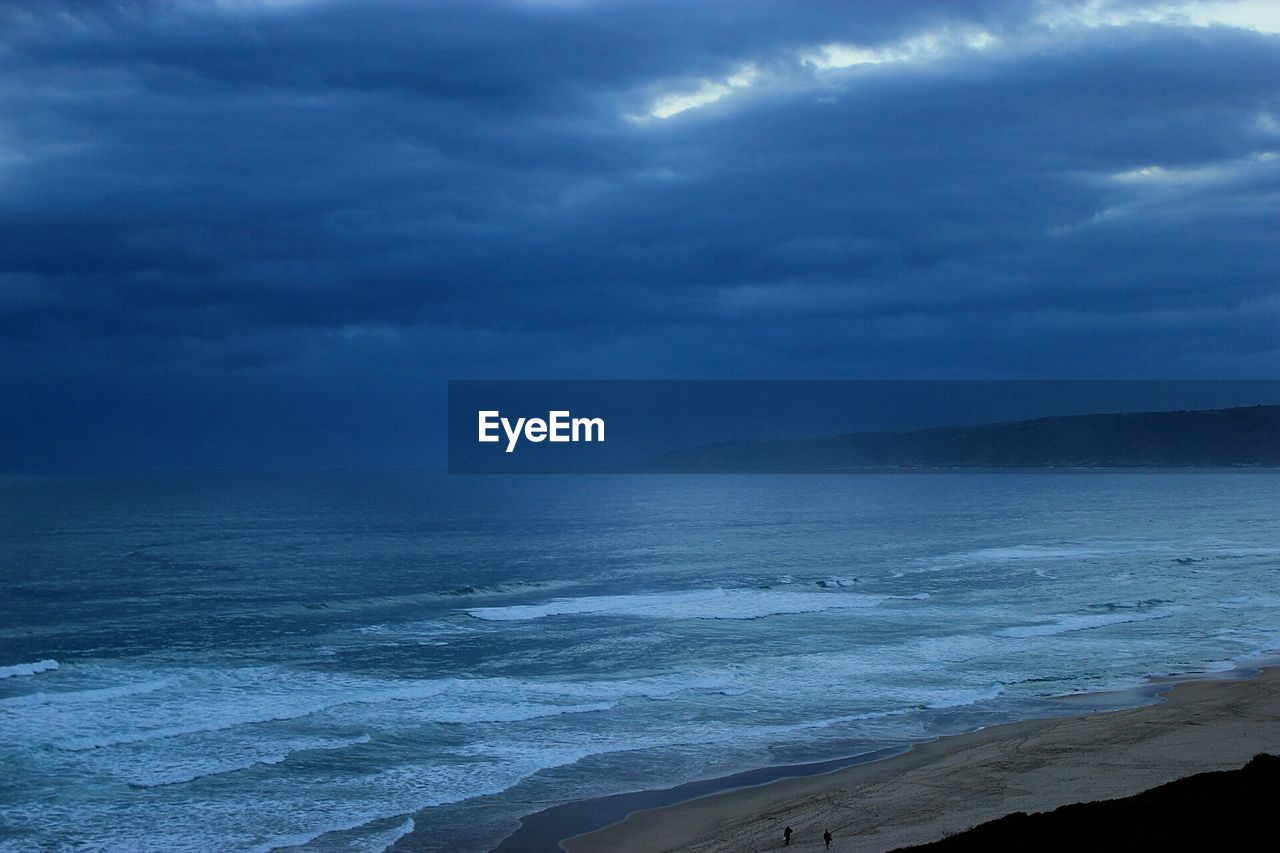 Scenic view of sea against dramatic sky