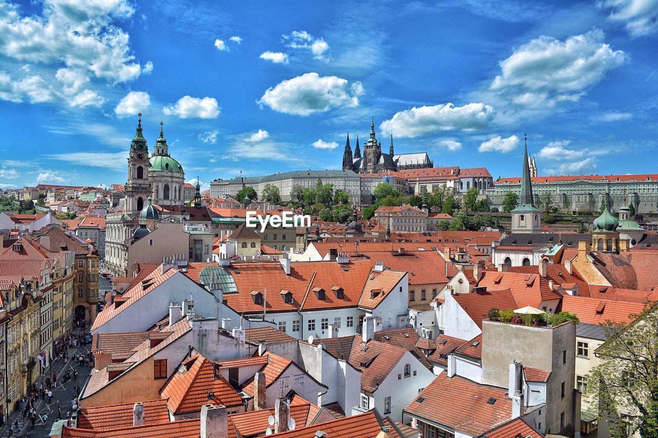 High angle view of buildings and prague castle against blue sky