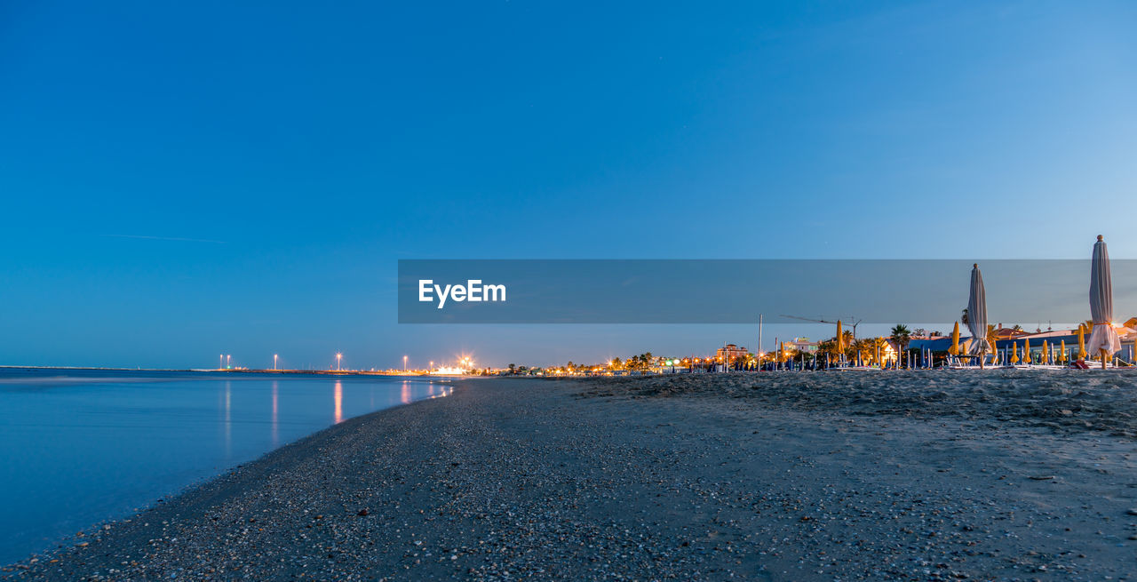 Scenic view of sea against blue sky at sunset