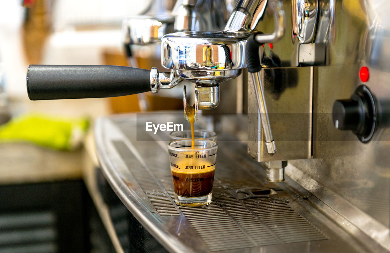 CLOSE-UP OF POURING COFFEE IN CUP