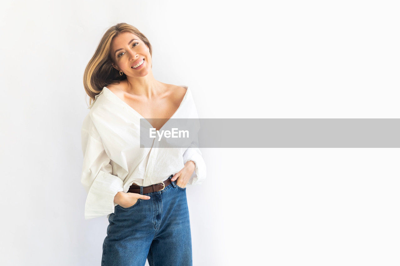 portrait of woman standing against white background