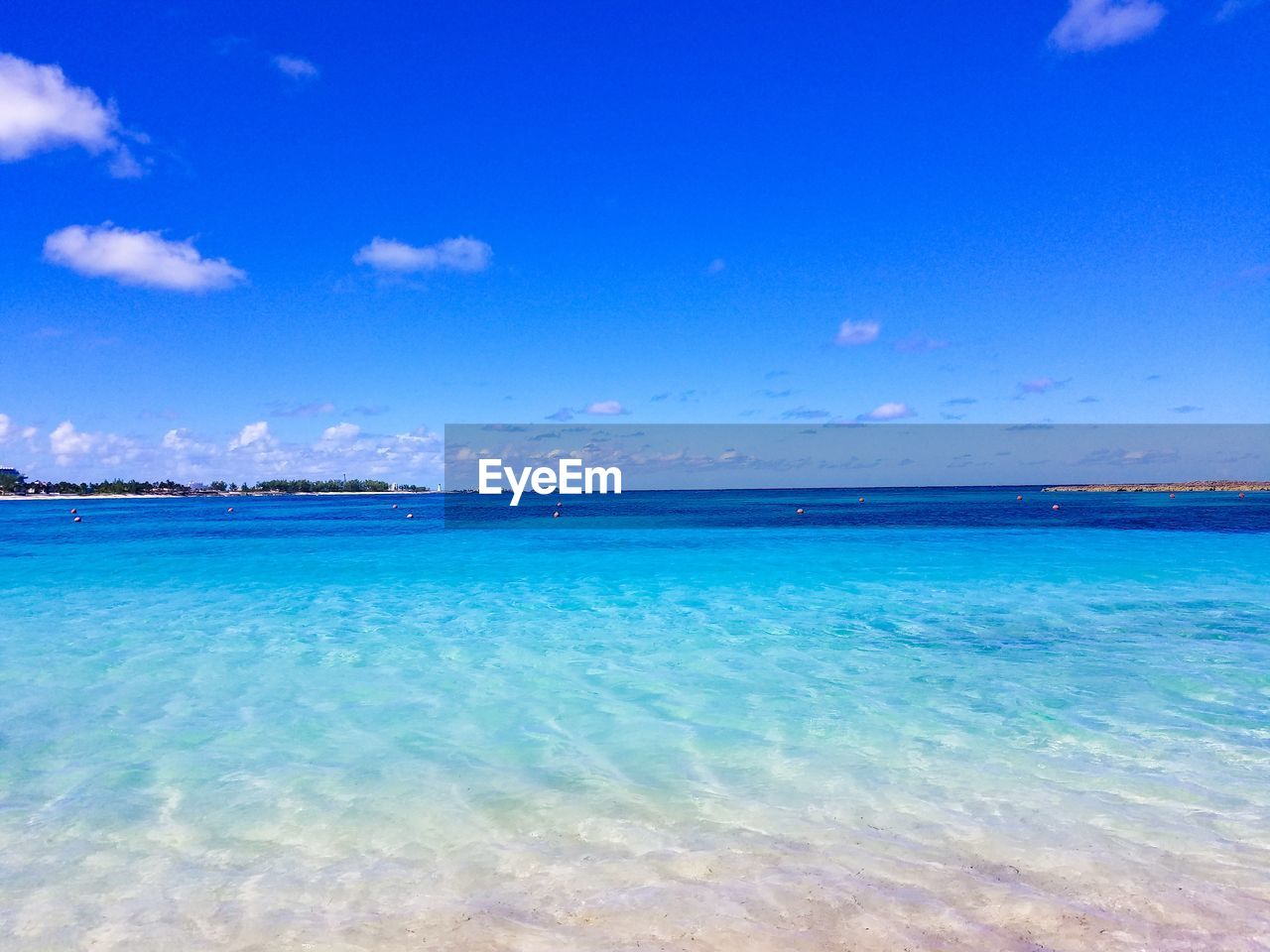 Scenic view of sea against blue sky