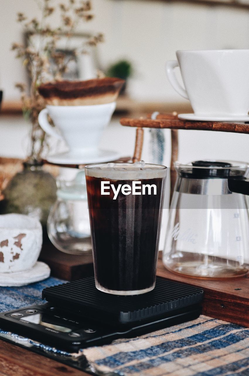 Close-up of iced coffee in glass on table at home