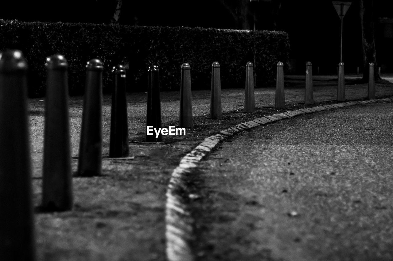 Bollards on sidewalk at night