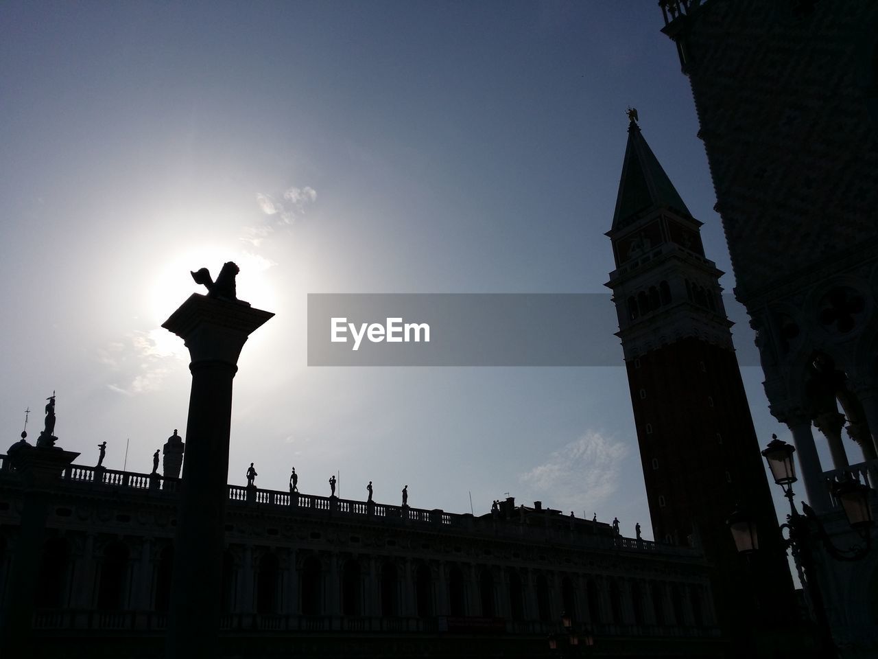 Low angle view of silhouette statue against sky