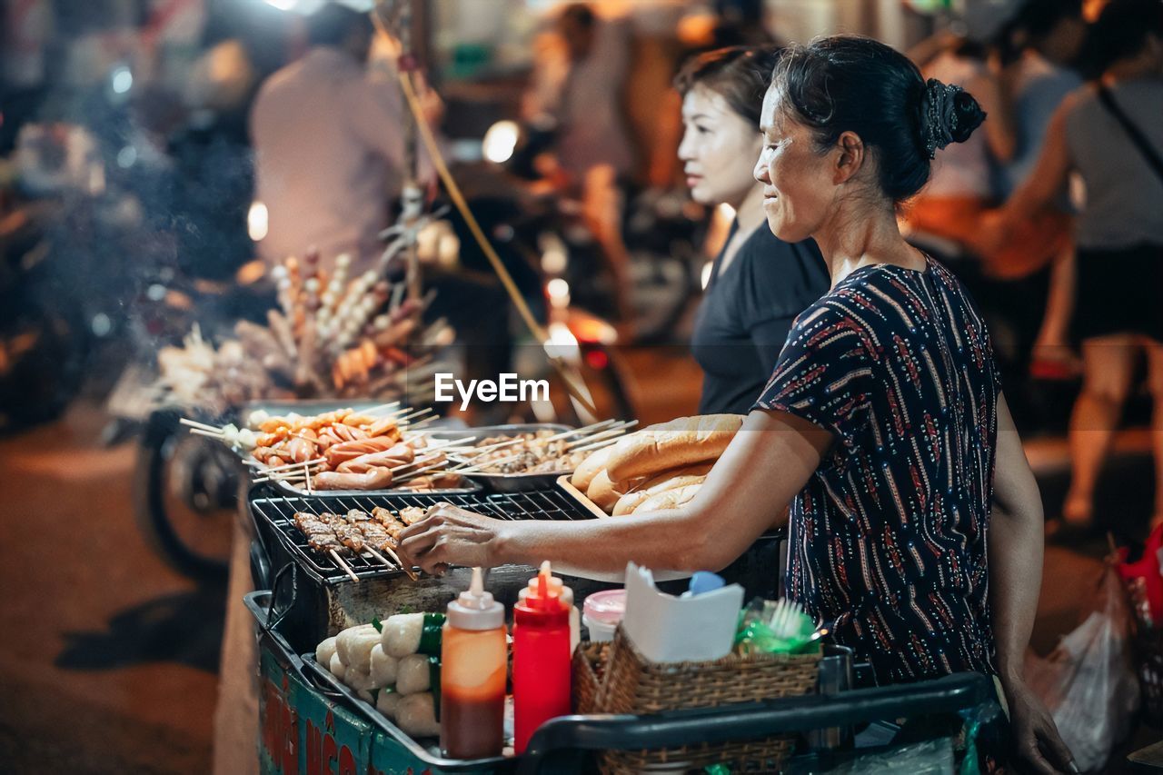 People having food at market stall