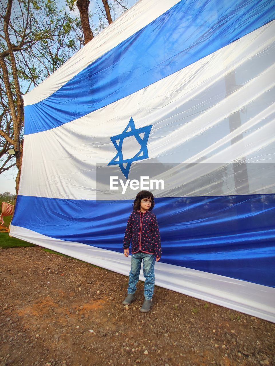Full length of girl standing by israel flag