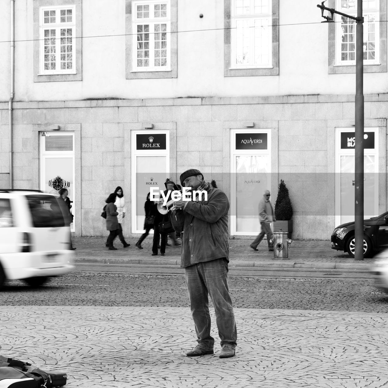 WOMAN STANDING ON PAVEMENT