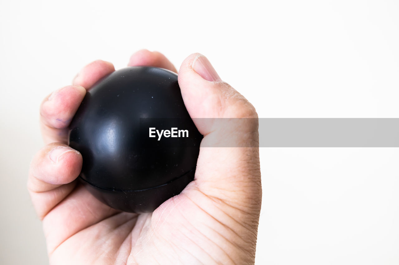 hand, holding, one person, studio shot, close-up, indoors, human eye, business, finger, ball, adult, cut out, single object, black