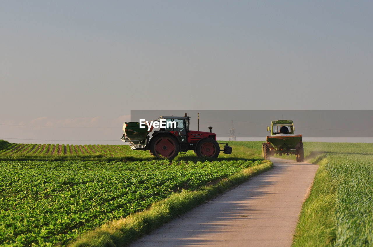 TRACTOR ON FARM AGAINST SKY