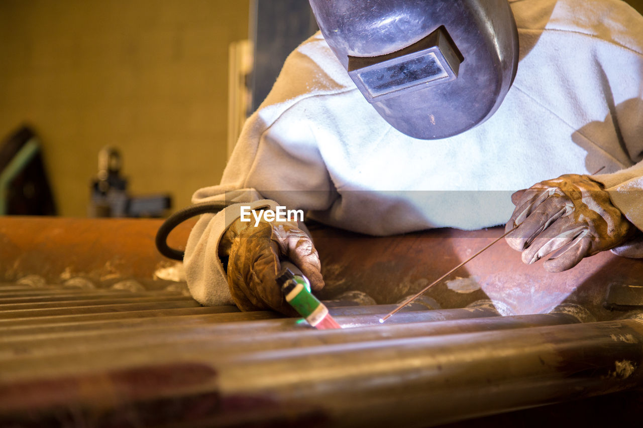Man welding metal at workshop