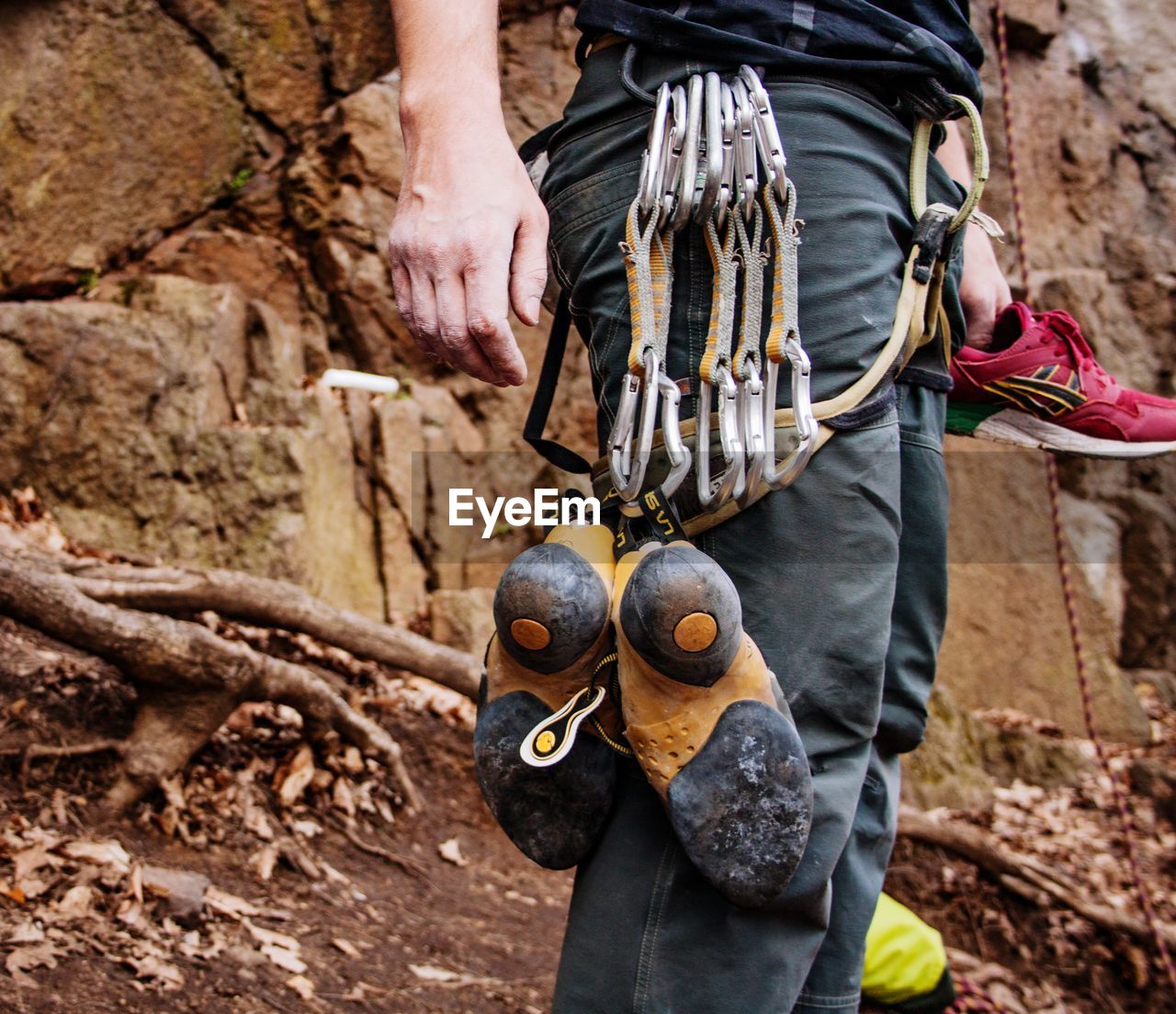 MIDSECTION OF MAN HOLDING ROCKS