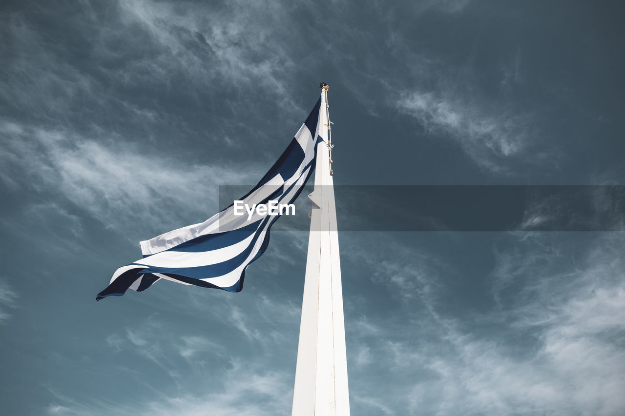 Low angle view of flag on pole against sky