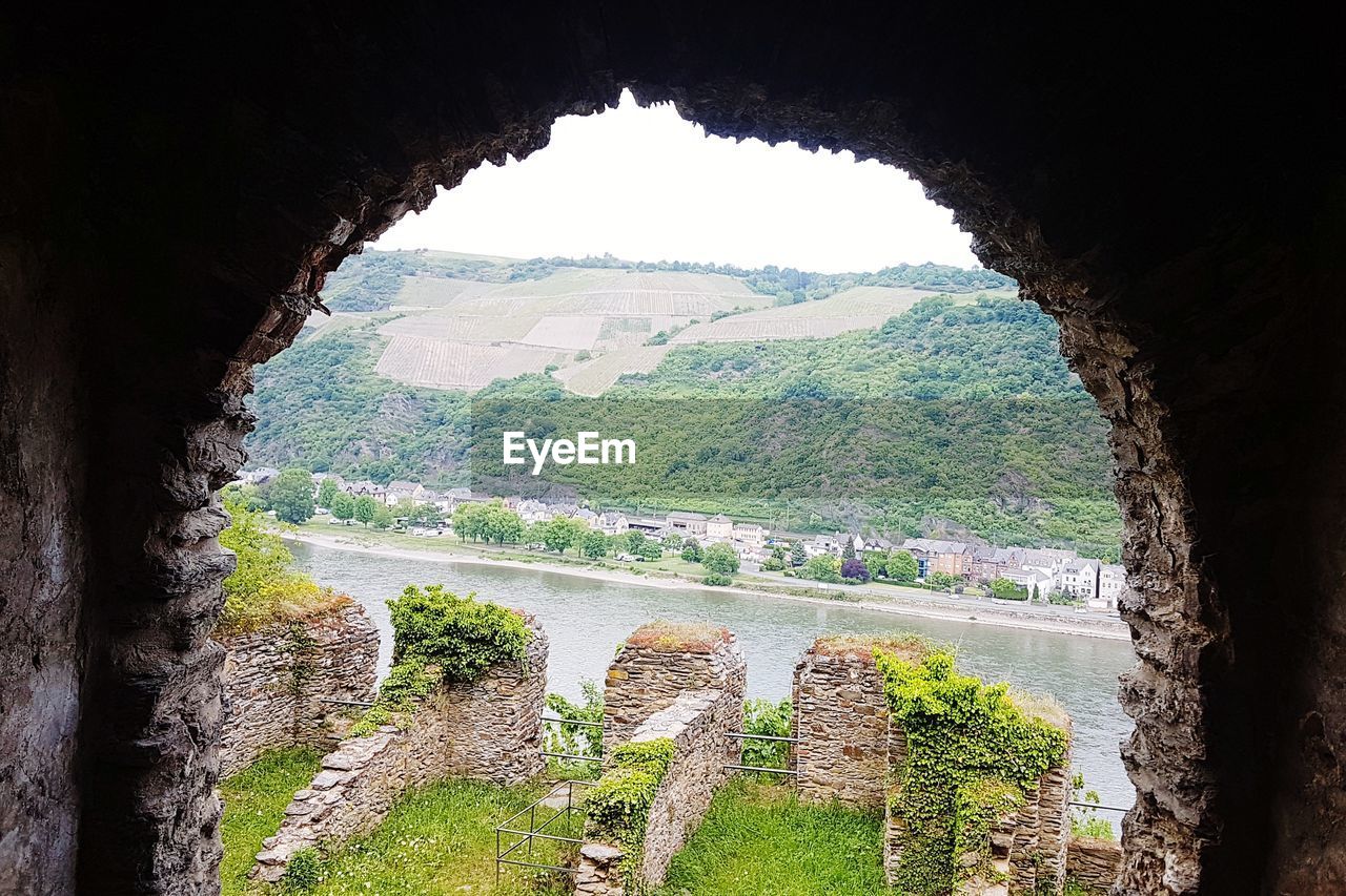 SCENIC VIEW OF MOUNTAIN SEEN THROUGH WINDOW