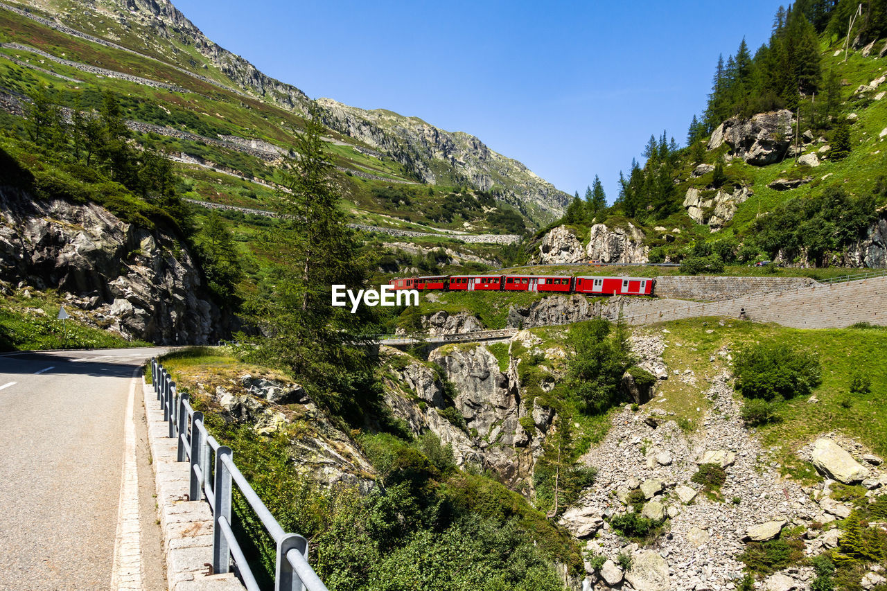 Typical swiss touristic red train climbing up the furka railway, switzerland