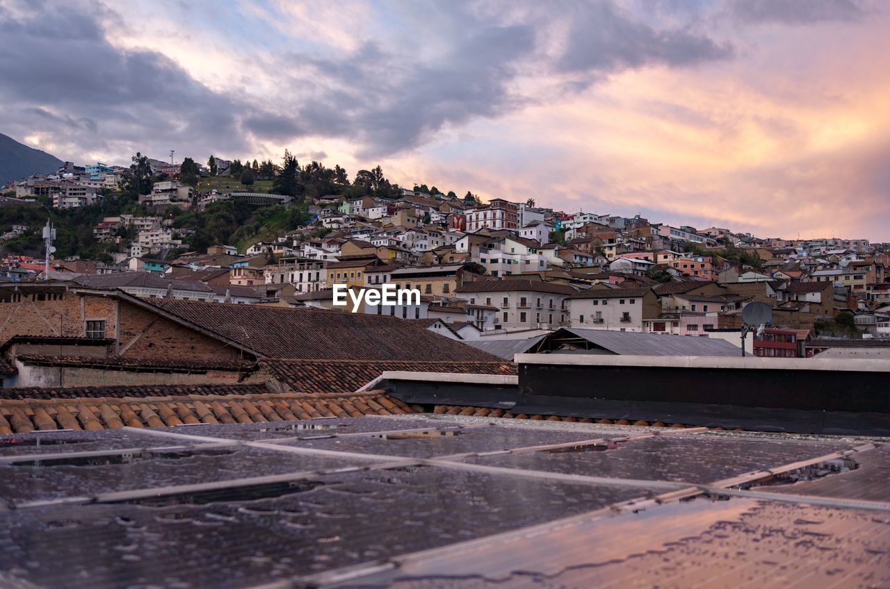 Townscape against sky at sunset