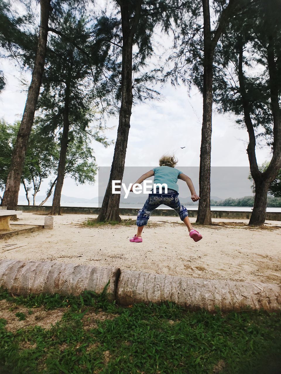 Rear view of girl playing on land