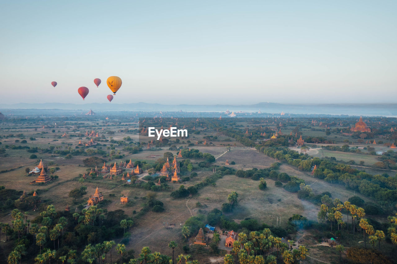 AERIAL VIEW OF HOT AIR BALLOON FLYING OVER CITY