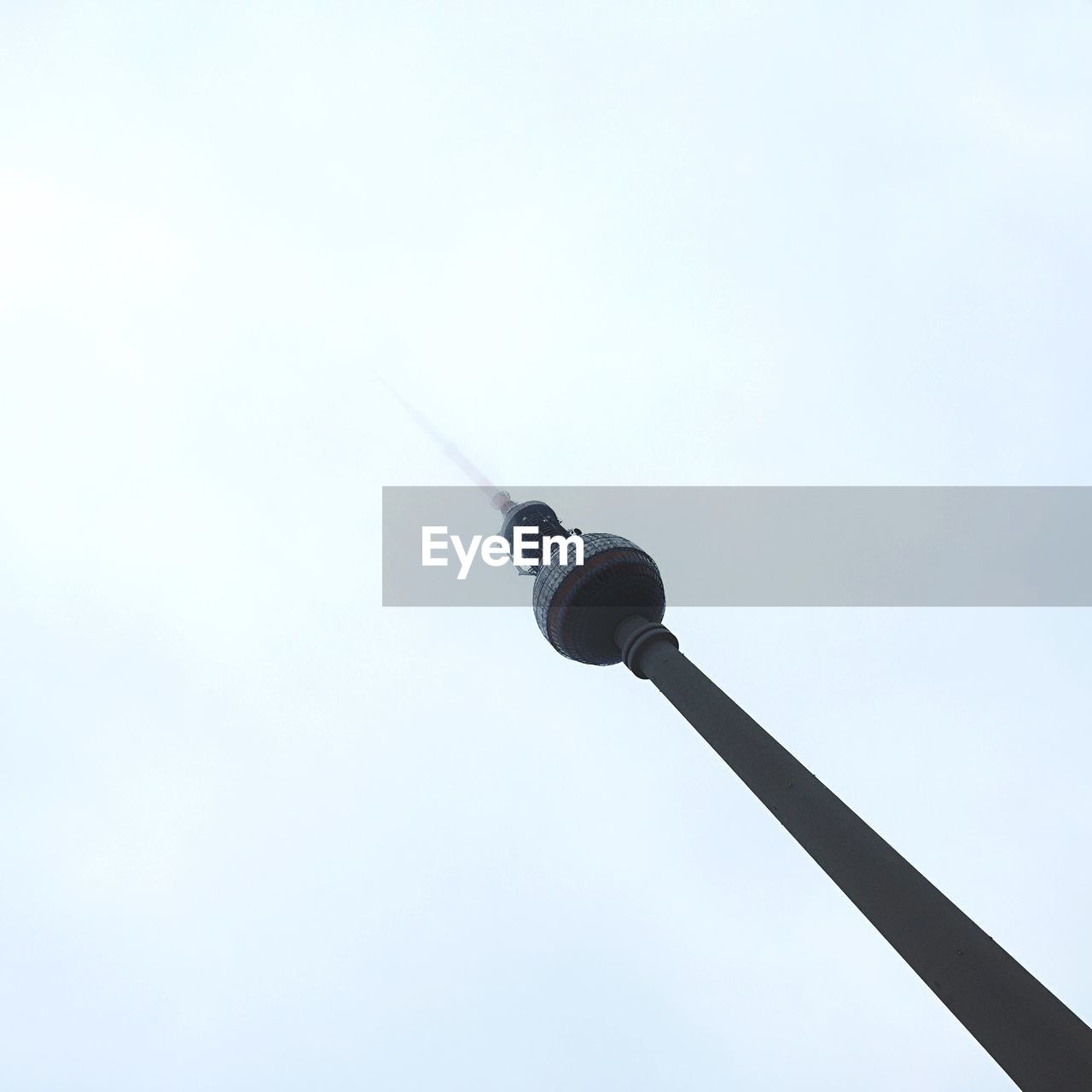 Tilt image of fernsehturm against sky