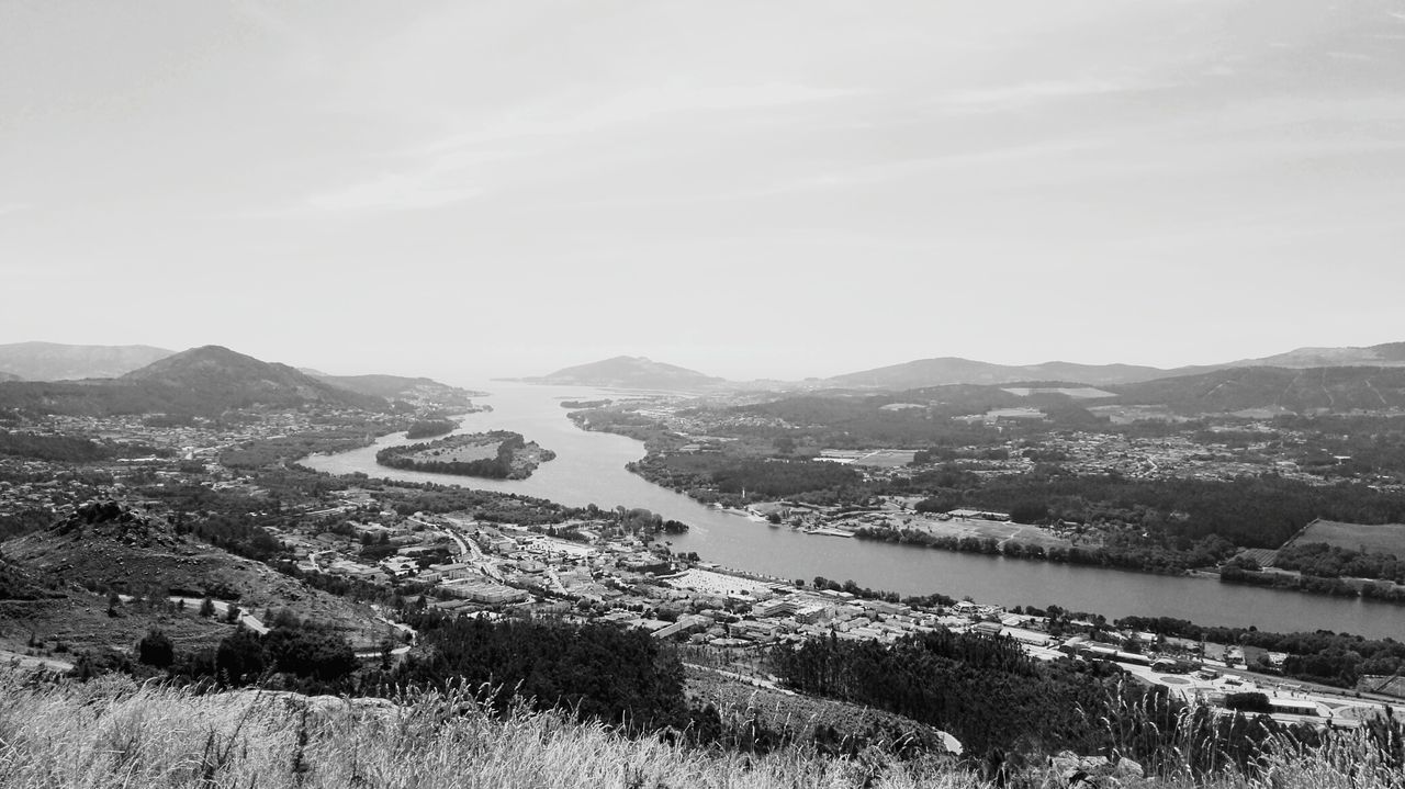 Scenic view of river against cloudy sky