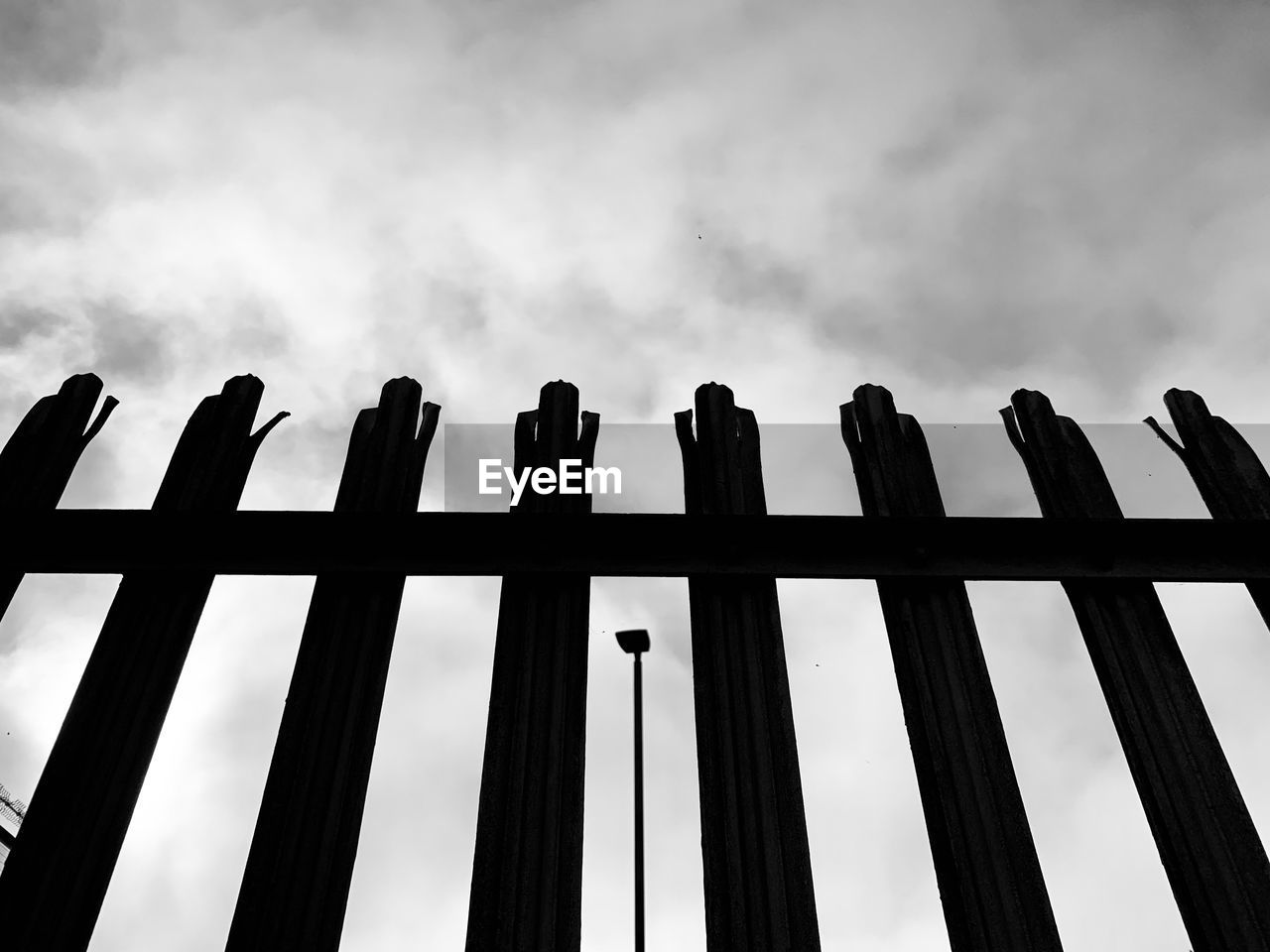 black, black and white, line, sky, monochrome, cloud, monochrome photography, no people, fence, white, nature, low angle view, protection, silhouette, security, font, architecture, wood, outdoors, day, darkness, in a row