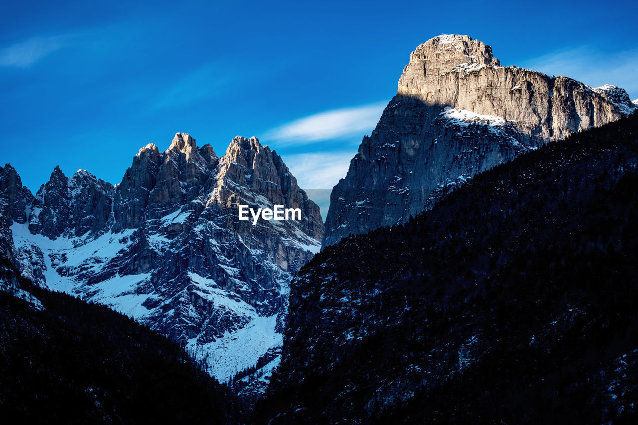 Scenic view of snowcapped mountain against blue sky