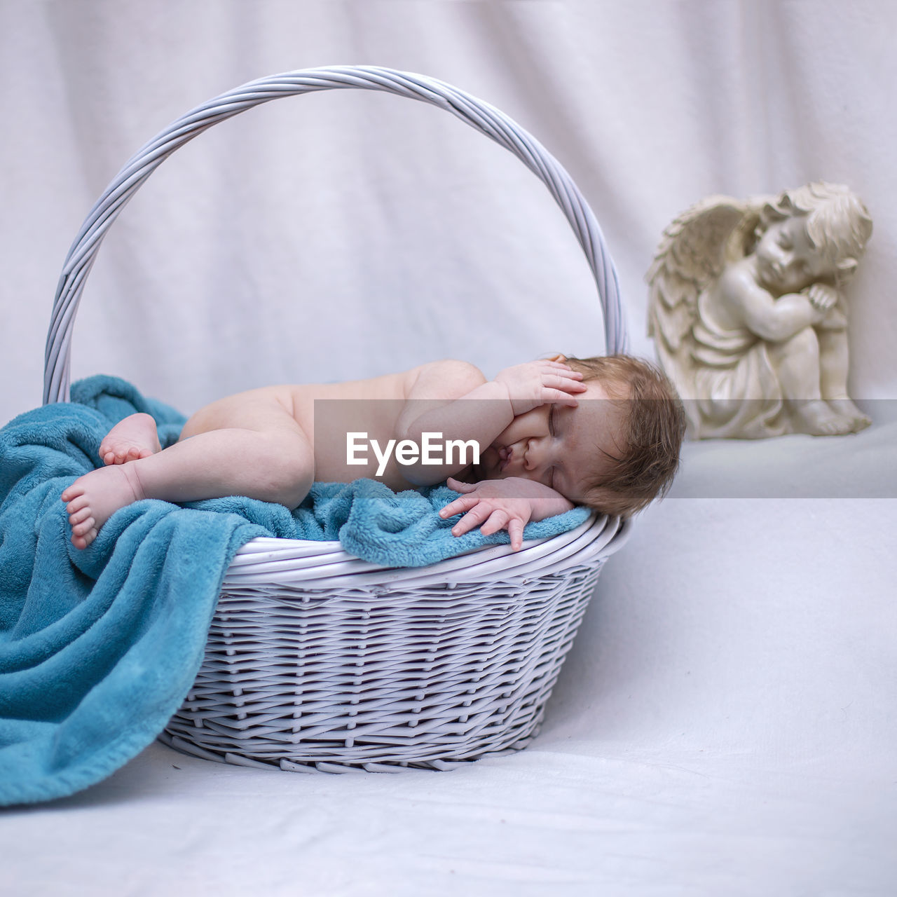 Cute baby sleeping in basket