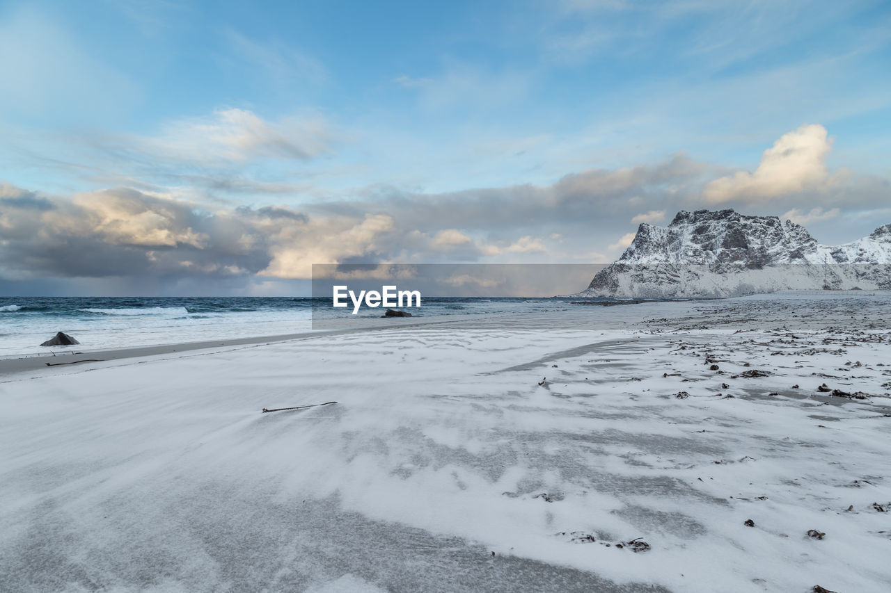 Scenic view of beach against sky during winter