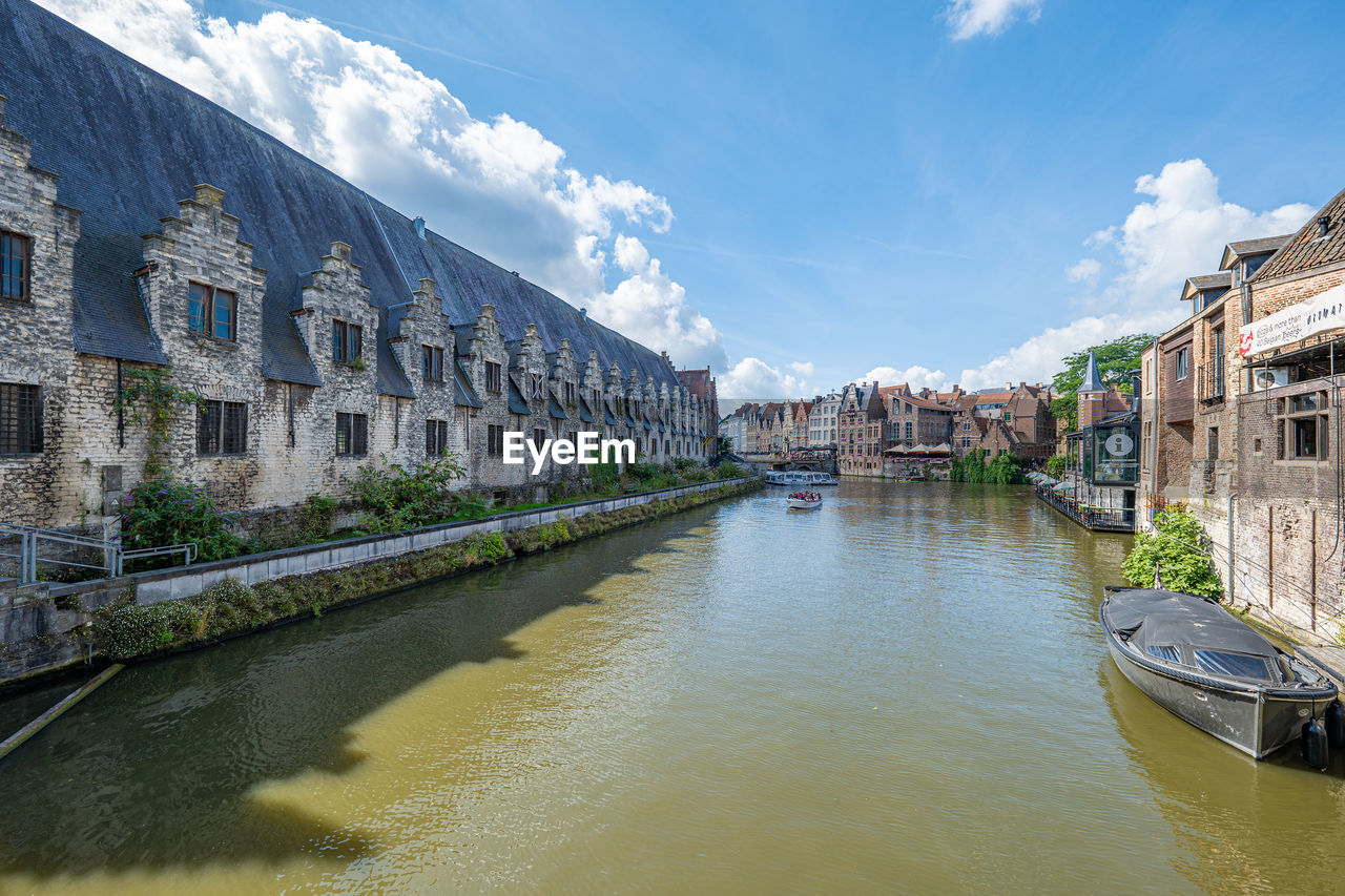 architecture, water, building exterior, built structure, canal, body of water, city, building, sky, waterway, nature, town, travel destinations, nautical vessel, travel, cloud, tourism, transportation, residential district, house, reflection, waterfront, bridge, channel, outdoors, landscape, environment, cityscape, no people, blue, day, mode of transportation, vacation, history, trip, holiday, the past, beauty in nature, old, vehicle, street, sunlight, multi colored