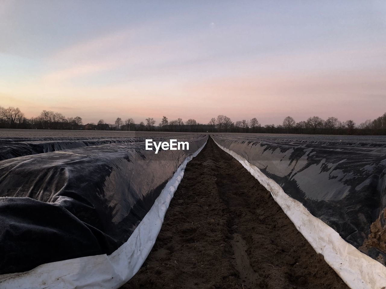 Scenic view of land against sky during sunset