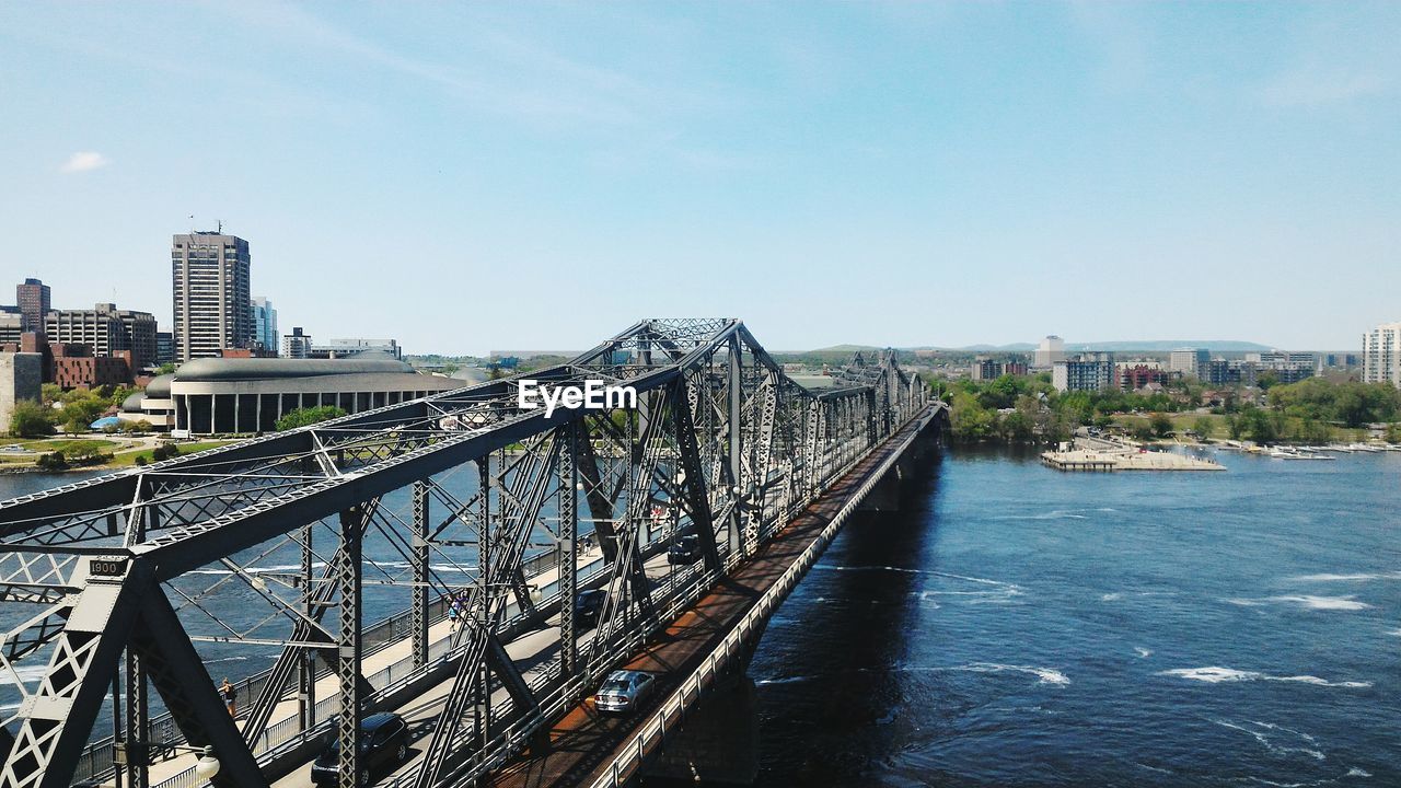 Bridge over river with city in background