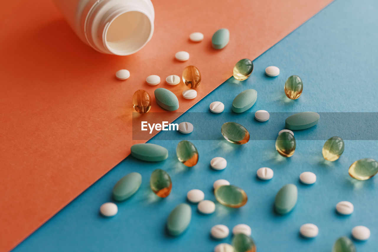 High angle view of pills and bottle on table