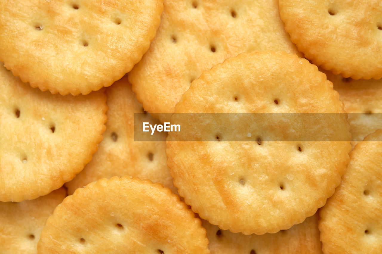 Top view of round crackers, food background.