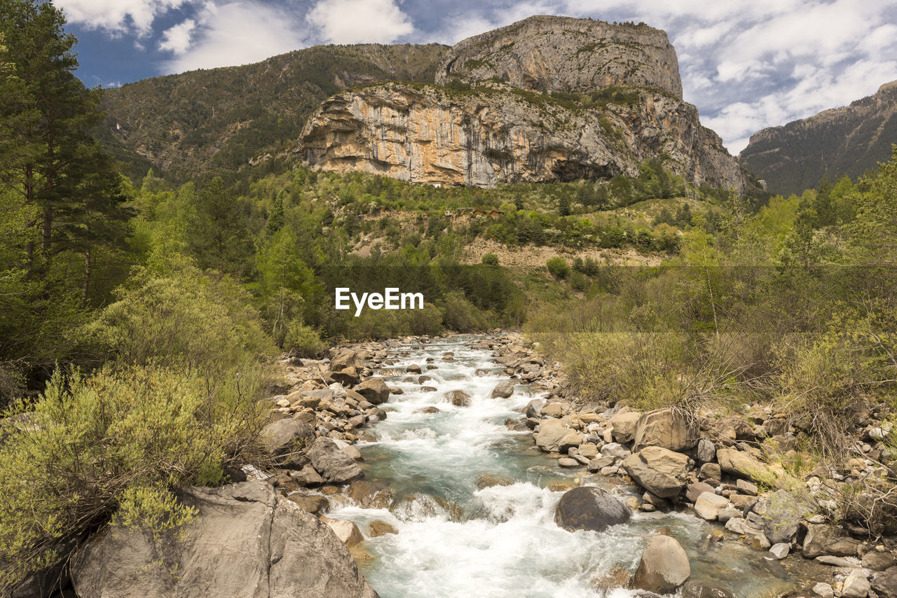 Scenic view of waterfall against sky