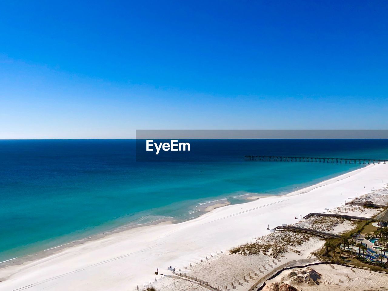 Scenic view of sea against clear blue sky