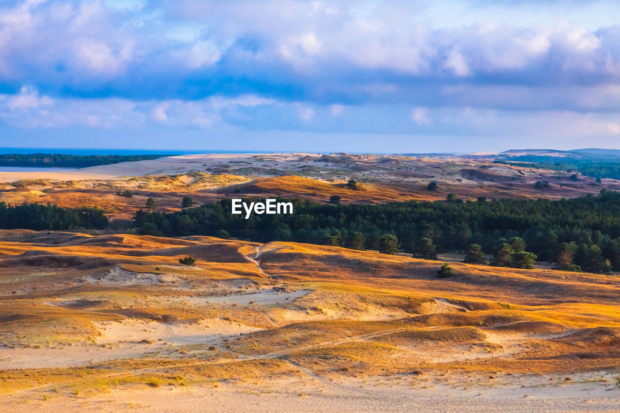 Scenic view of landscape against cloudy sky