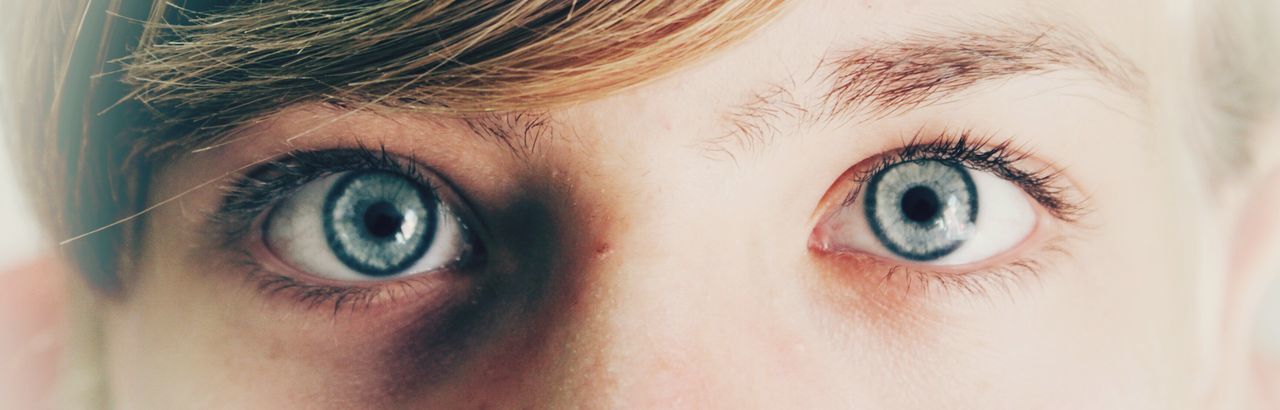 Close-up portrait of woman with gray eyes