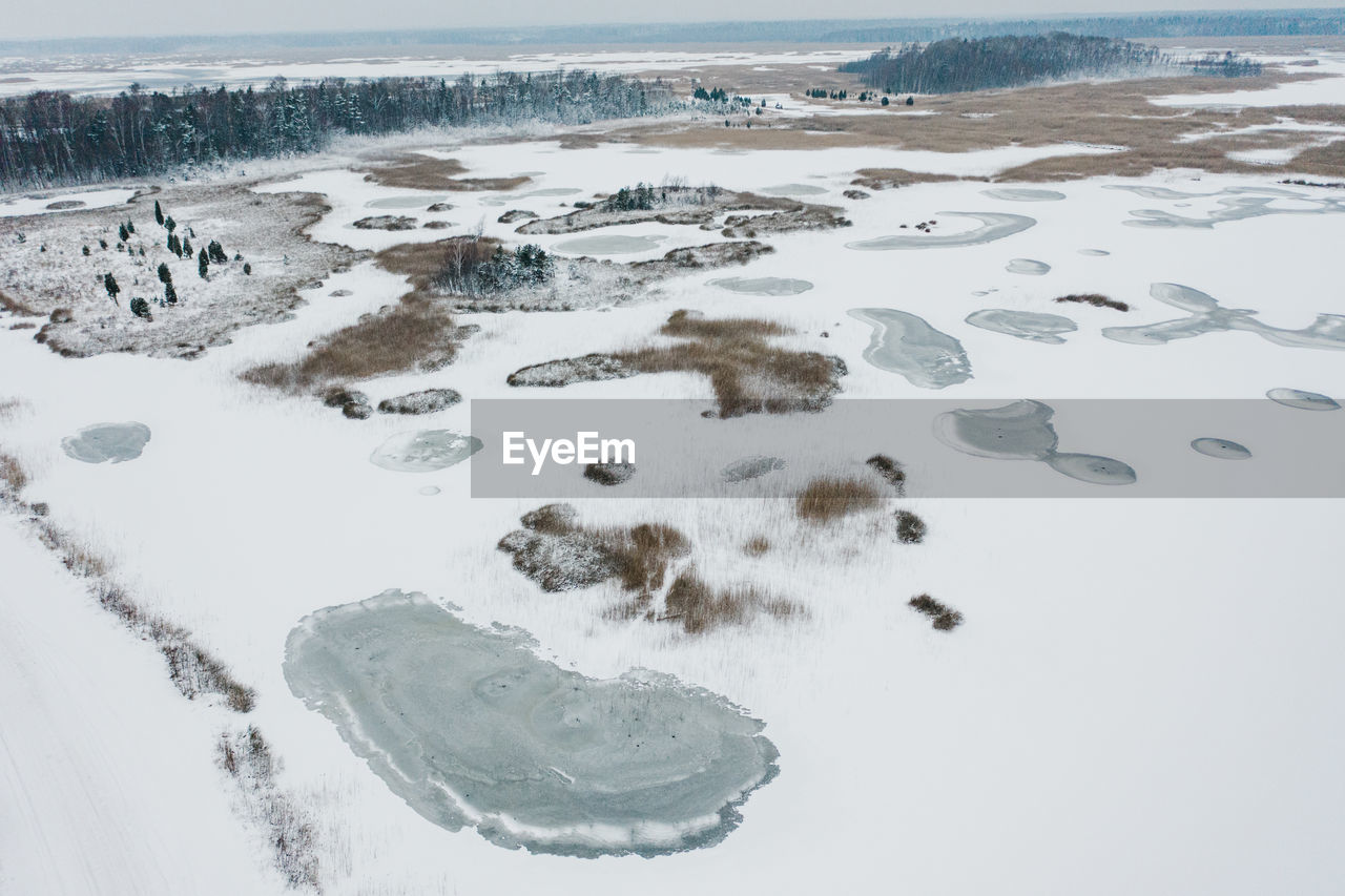 AERIAL VIEW OF FROZEN LAKE LAND
