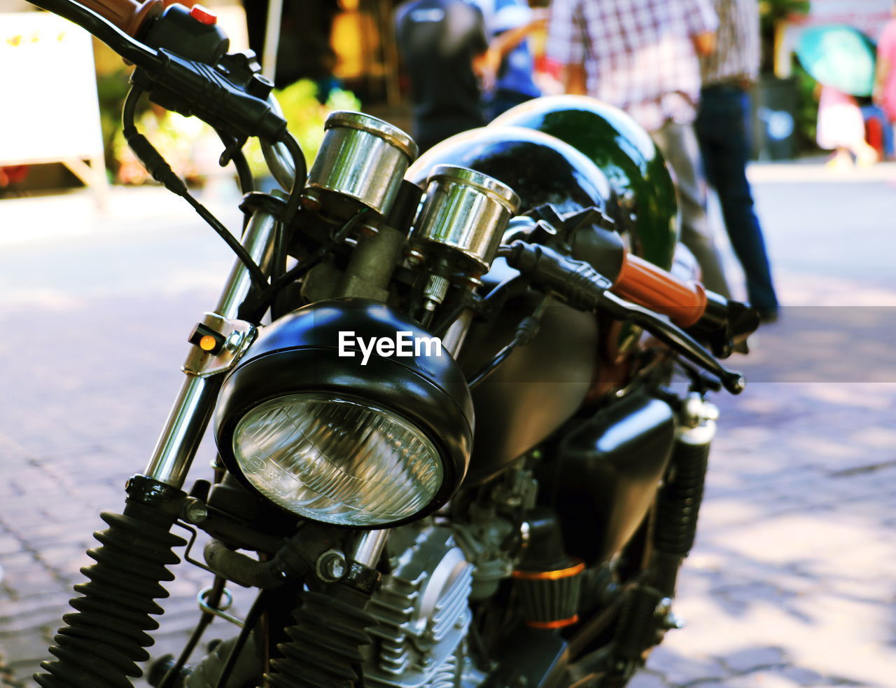 Close-up of motorcycle on street in city