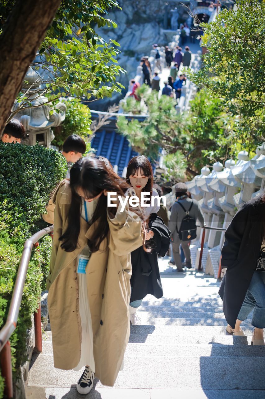 GROUP OF PEOPLE WALKING ON STREET