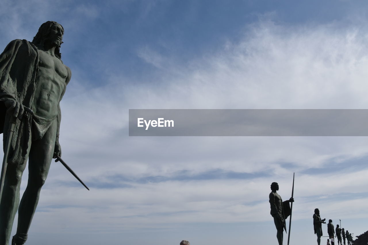 LOW ANGLE VIEW OF STATUE AGAINST SKY AT SUNSET