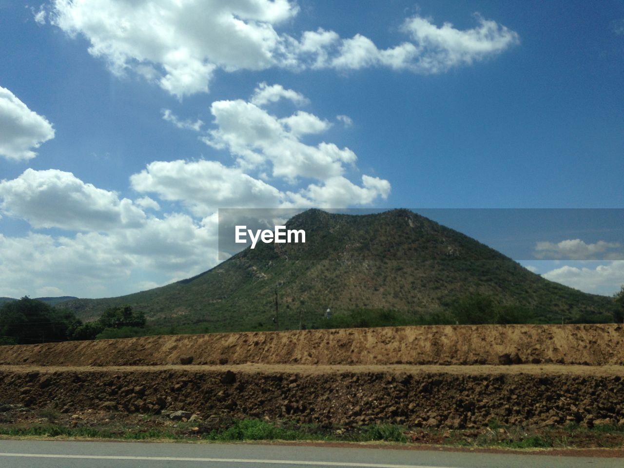 Scenic view of mountain against cloudy sky