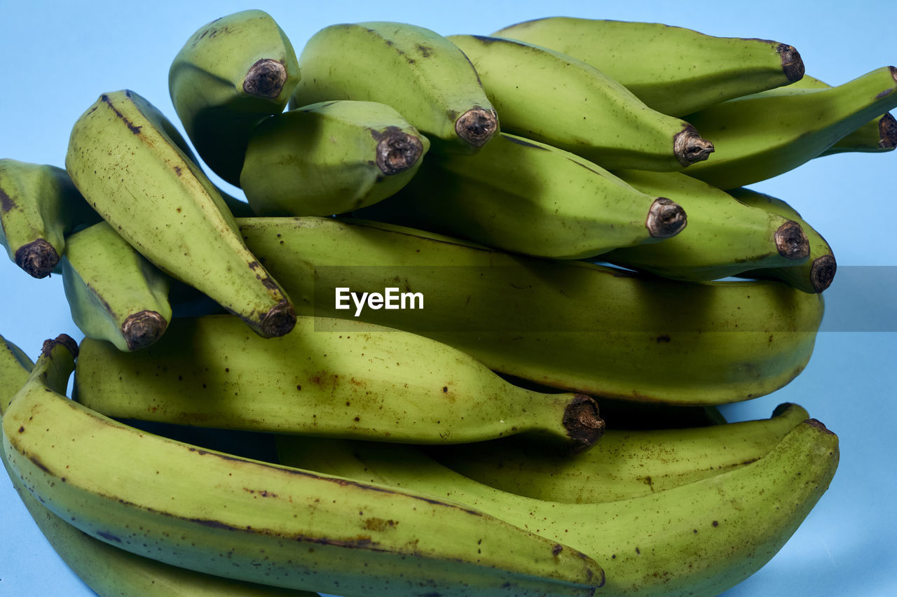 Fresh green banana on blue background, maqueno barraganete dominico